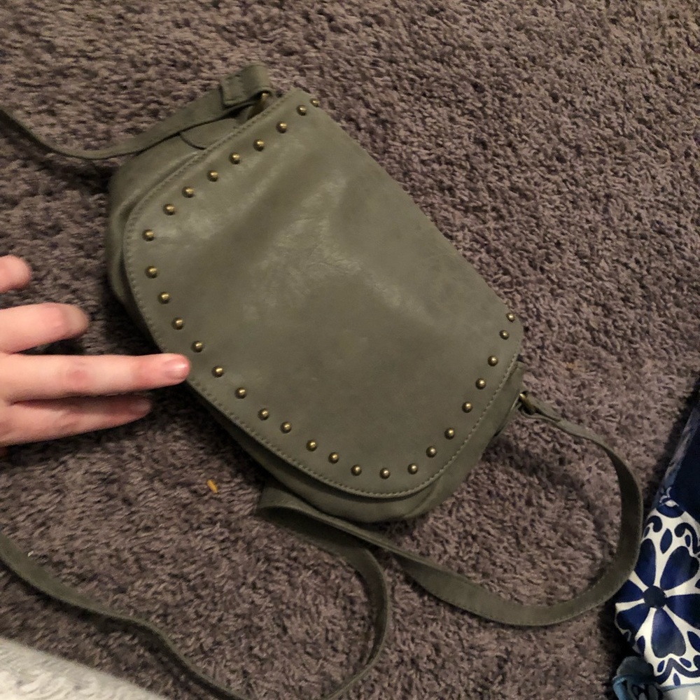 Grey messenger bag with magnetic button close.